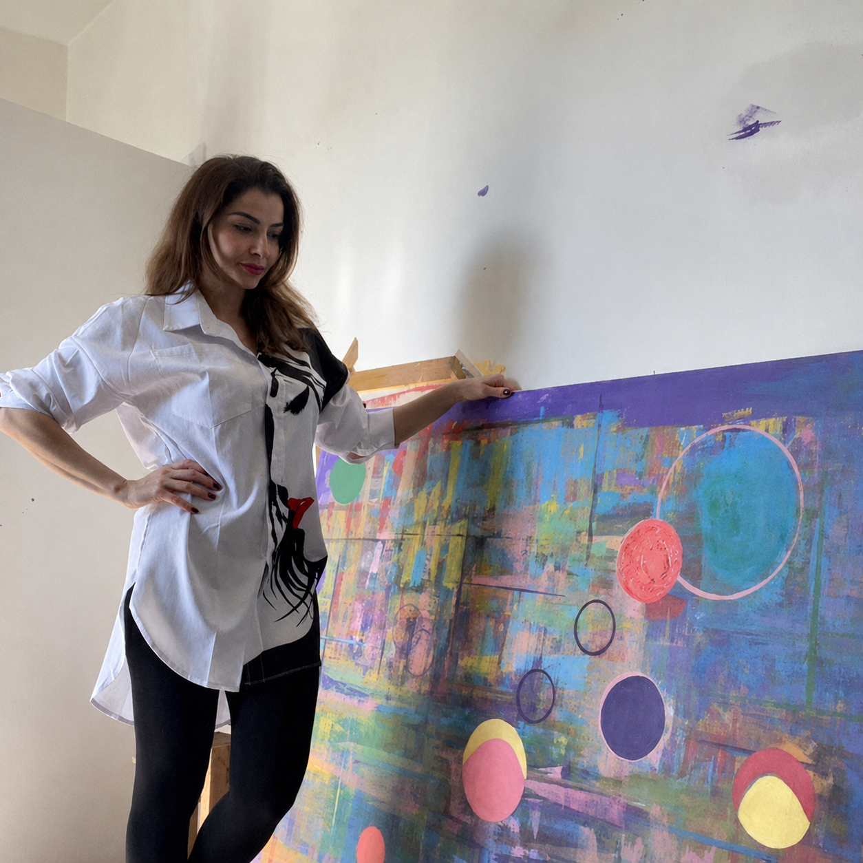 Negar Afshar in her London studio beside one of her abstract paintings